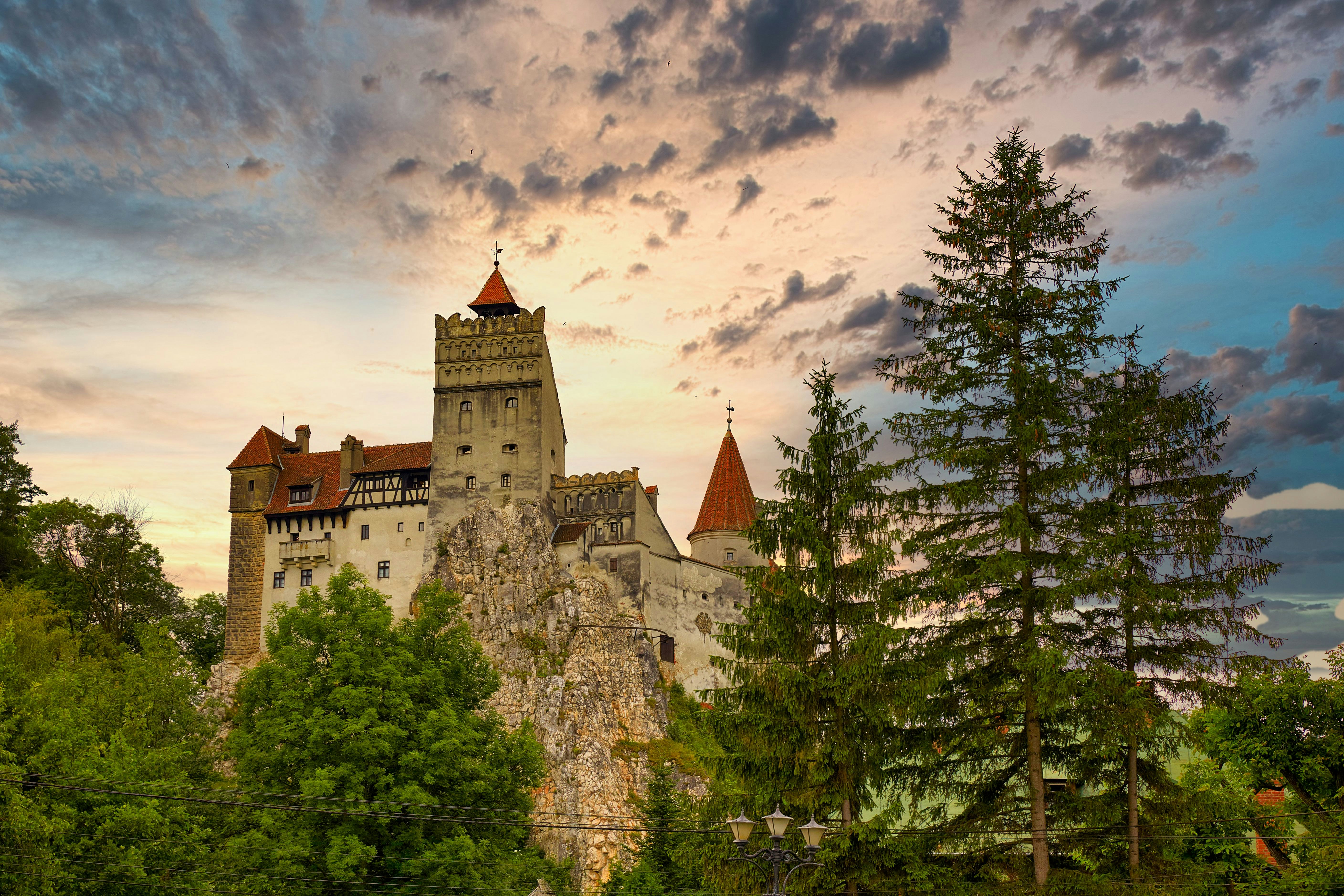 white and brown concrete castle under cloudy sky during daytime